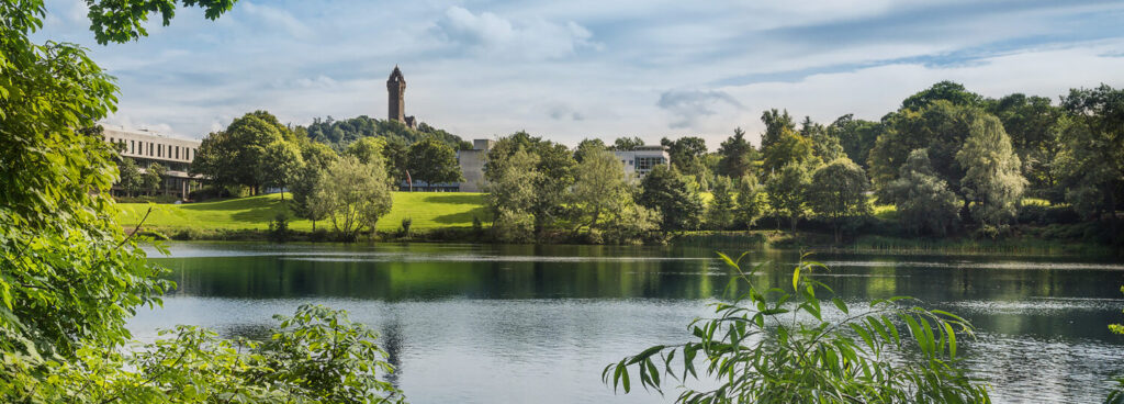 University of Stirling, with Wallace Monument pictured - view from the loch